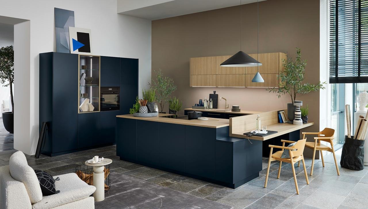 Real installed Nolte kitchen in navy blue with wood countertop and dining area